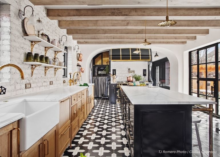 ru-home-tablet The ru-home-tablet features a spacious kitchen with black-and-white tile floors, wooden cabinets, a farmhouse sink, marble countertops, open shelves with green dishware, and large windows that bring in natural light.