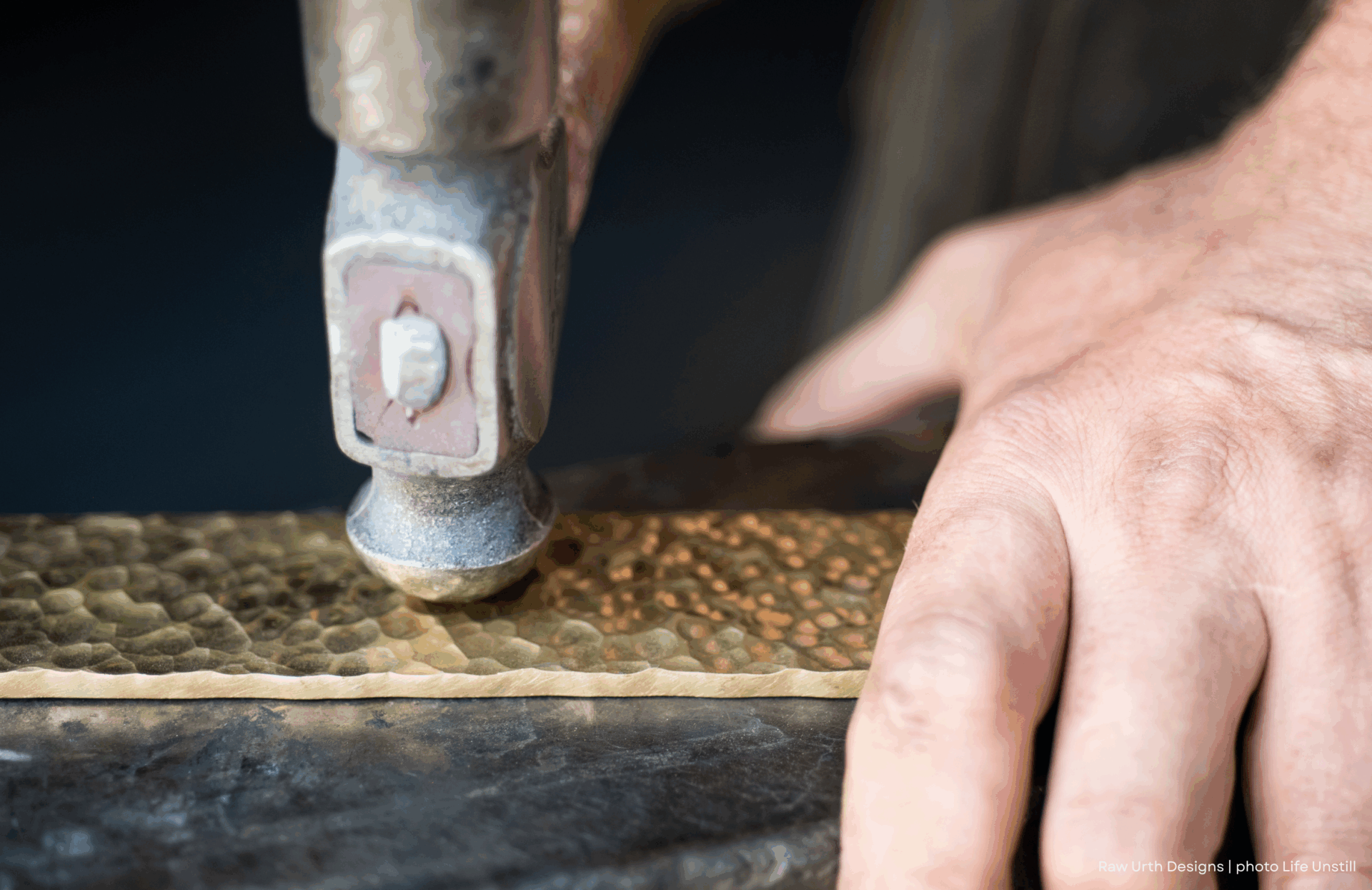 A person’s hand holds product 5, using a hammer to create a hammered texture on its brass surface.