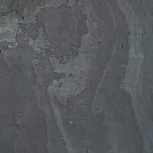 Asita features a dark gray textured concrete wall with subtle, uneven patterns and lighter streaks, showcasing natural, weathered tones. Its surface displays a range of grays and irregular, cloud-like formations for a unique look.
